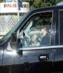 Britney Spears, with baby on lap driving SUV