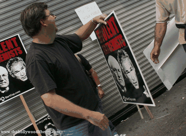 A guy gives away a free bartcop sign at the anti war march and rally in L.A. 092405